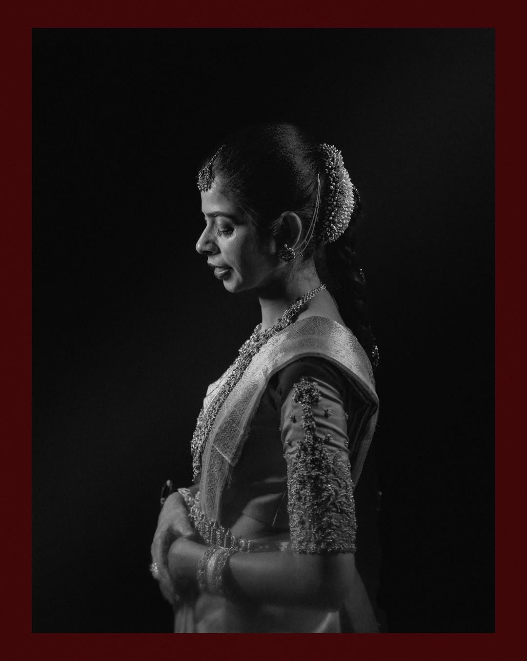 Bride in black and white, adjusting her jewellery